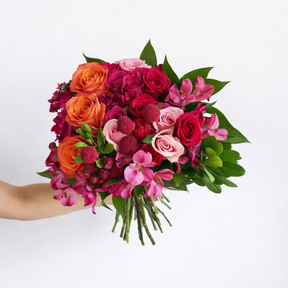 Bouquet of various pink flowers: Billy balls, alstroemerias, carnations, and roses.